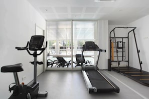 A gym with treadmills, an elliptical, and a weight machine. - Apartment in Cavalaire-sur-Mer near Beach (Cavalaire sur Mer)