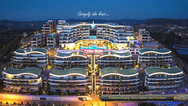 A modern hotel with a central pool and multiple curved buildings. - Elite Luxury Suite & Spa (Alanya)