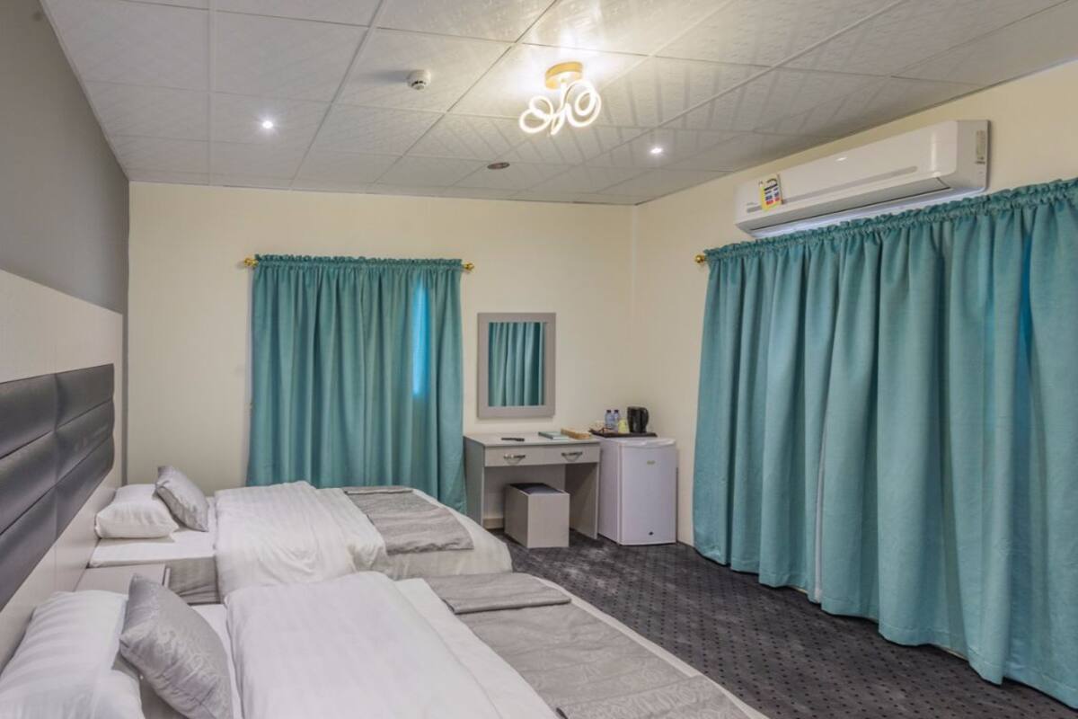 Suite Grand | Cortinas blackout, camas extra, wifi gratis y ropa de cama