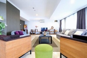 Apartment, 4 Bedrooms | Living area | Flat-screen TV