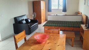 A cozy living room with a wooden table, chairs, a sofa, and a window with curtains. - Bahari 1st floor mountain, sea and riviera view (3 p) (Morro)