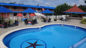 Outdoor pool, open 9:00 AM to 7:00 PM, pool umbrellas