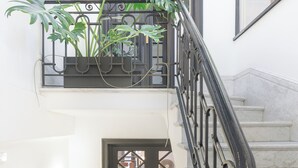 A staircase with a black railing leading to a second floor. - FAUNA Montevideo (Montevideo)