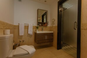 A modern bathroom with a toilet, sink, vanity, and a glass shower door. - La Rosa Waves Beach - Couple & Families Only (Hurghada)