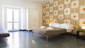 A bedroom with a bed, bedside table, and a wardrobe.