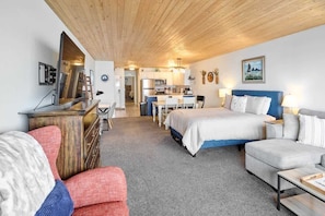 Relax in this inviting room with a comfortable bed, sofa, and desk area.