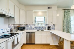 Enjoy cooking in this well-equipped kitchen with a dishwasher, microwave, and stove.