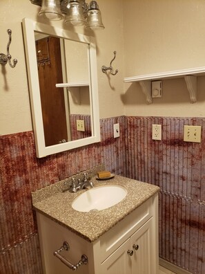 A bathroom with a sink, mirror, and towel rack. - Private 20 Acres with Wisconsin Creek flowing through the front yard. (Twin Bridges)