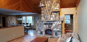 Relax in a spacious living area with a fireplace, dining table, and comfortable seating.