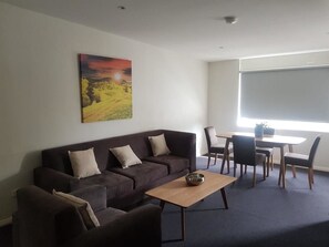 Deluxe Apartment, 2 Bedroom (1 King Bed, 1 Single Bed and 1 Tri-Bunk) | Living room | 50-inch Smart TV with digital channels, TV - Carlton Suites (Goulburn)