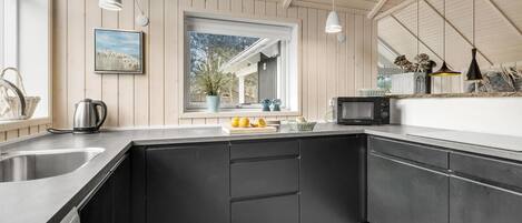 Fridge, stovetop, dishwasher, coffee/tea maker