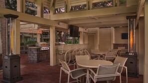 Enjoy al fresco dining and relaxation in this outdoor patio area, featuring a barbecue station, comfortable seating and floor heaters.