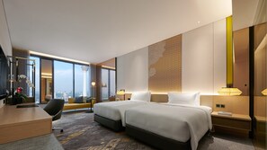A modern hotel room with a large bed, a desk, a chair, and a view of the city skyline. - EQ Kuala Lumpur (Kuala Lumpur)