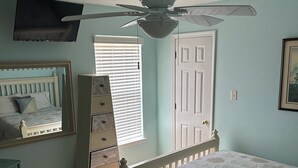 A bedroom with a bed, dresser, ceiling fan, and a door. - Foley. 20 mins to beaches, close to Tanger Outlet, Owa, sports complex (Foley)