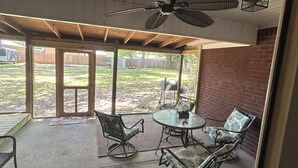 A covered patio area with a ceiling fan, outdoor seating, and a view of the backyard. - Foley. 20 mins to beaches, close to Tanger Outlet, Owa, sports complex (Foley)