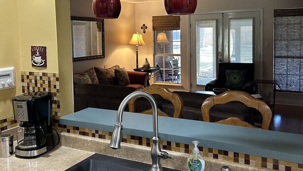A kitchen with a black sink, a coffee maker, and a sign above the sink that reads "GATHER TOGETHER". - Foley. 20 mins to beaches, close to Tanger Outlet, Owa, sports complex (Foley)