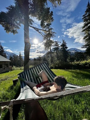 Relax in a hammock amidst a serene mountain backdrop.