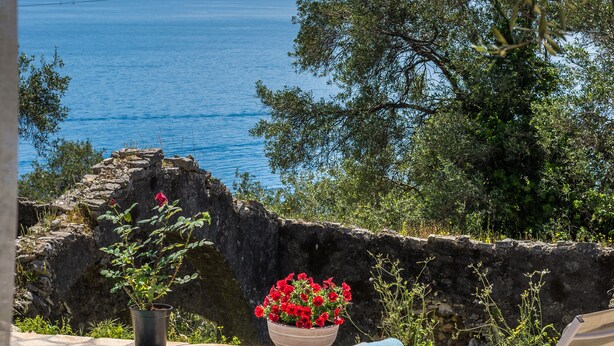Area piscina con lettini e vista mare.