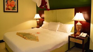 A hotel room with a bed, two bedside lamps, a nightstand with a phone, and a painting on the wall. - Lewi Hotel Piazza (Awassa)