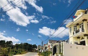 Houses line the quiet street, each with its own unique facade and outdoor space.