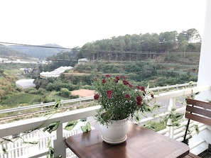 Enjoy a serene view of the surrounding landscape from this balcony.