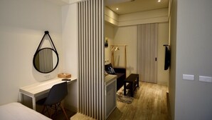 A modern bedroom with a desk, chair, and a large mirror. - Sakagami Hotel (Tainan)