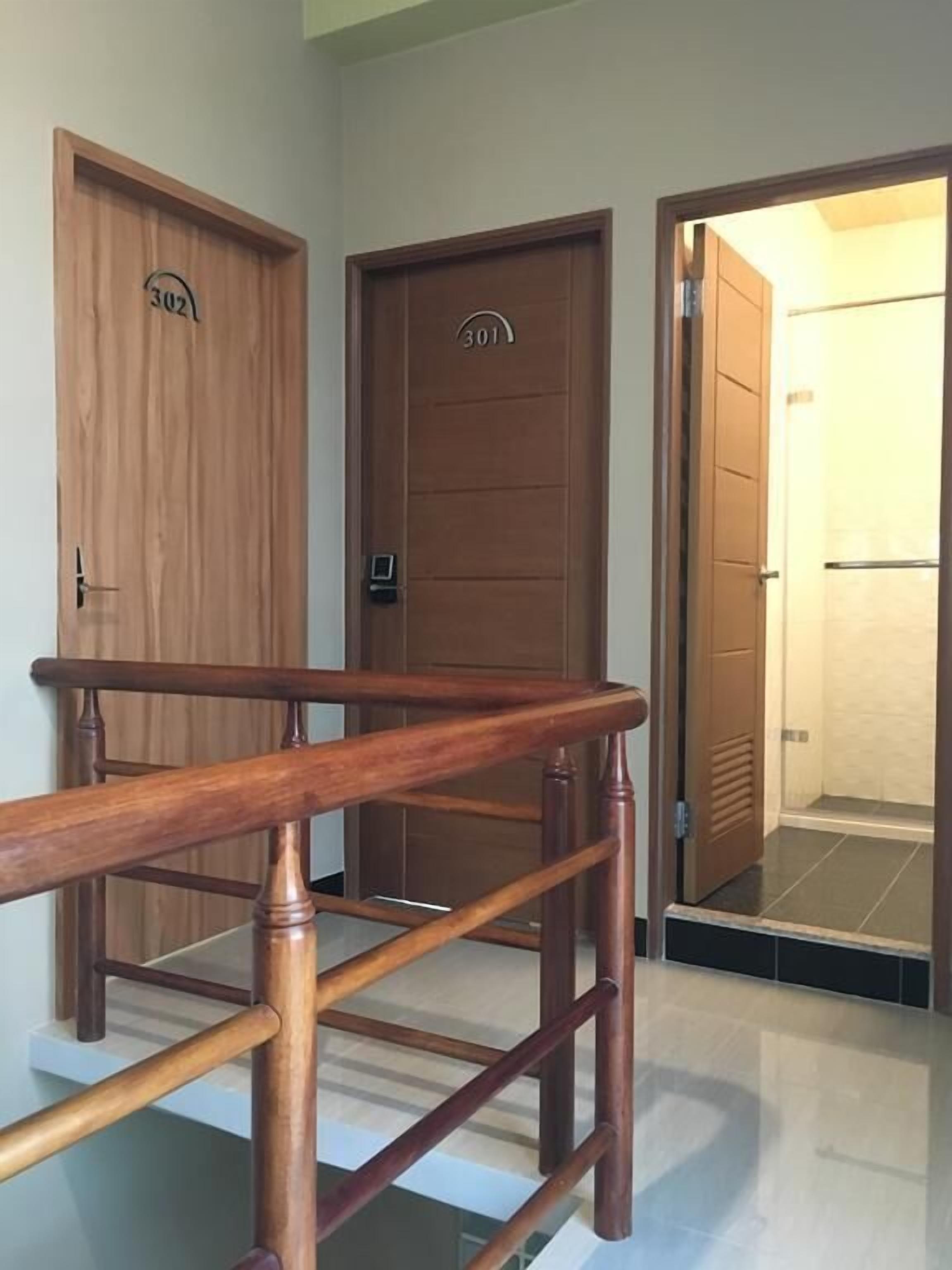 A wooden staircase leading to a room with a door labeled "301".