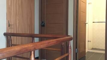 A wooden staircase leading to a room with a door labeled "301".