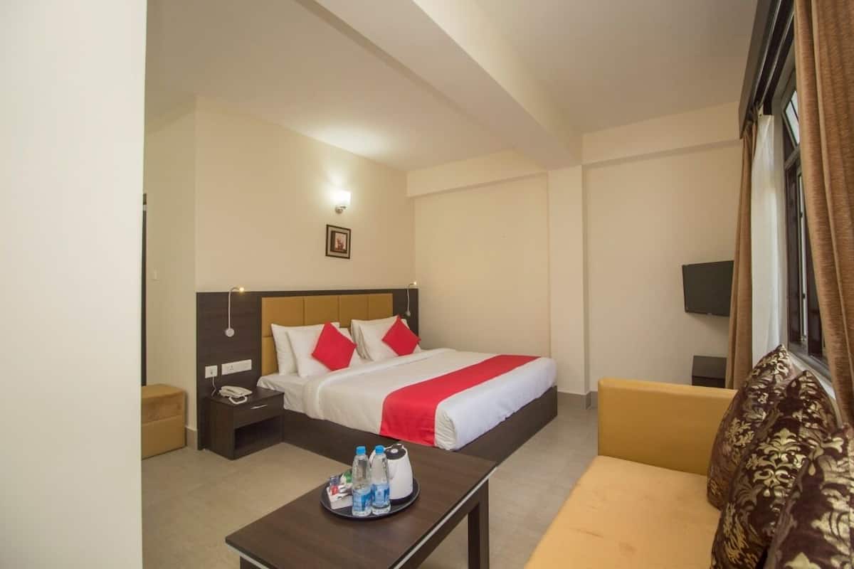 Ein Hotelzimmer mit Bett, Nachttisch und einer Couch.