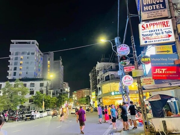 A street with various hotel signs, including 'Sapphire Hotel' and 'Unique Hotel'. - Sapphire Hotel Hue (Hue)