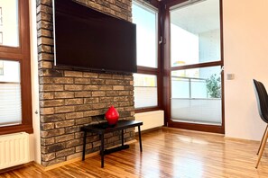 Premium Apartment, 1 Bedroom, Balcony, City View | Living room | 50-inch flat-screen TV with cable channels, TV