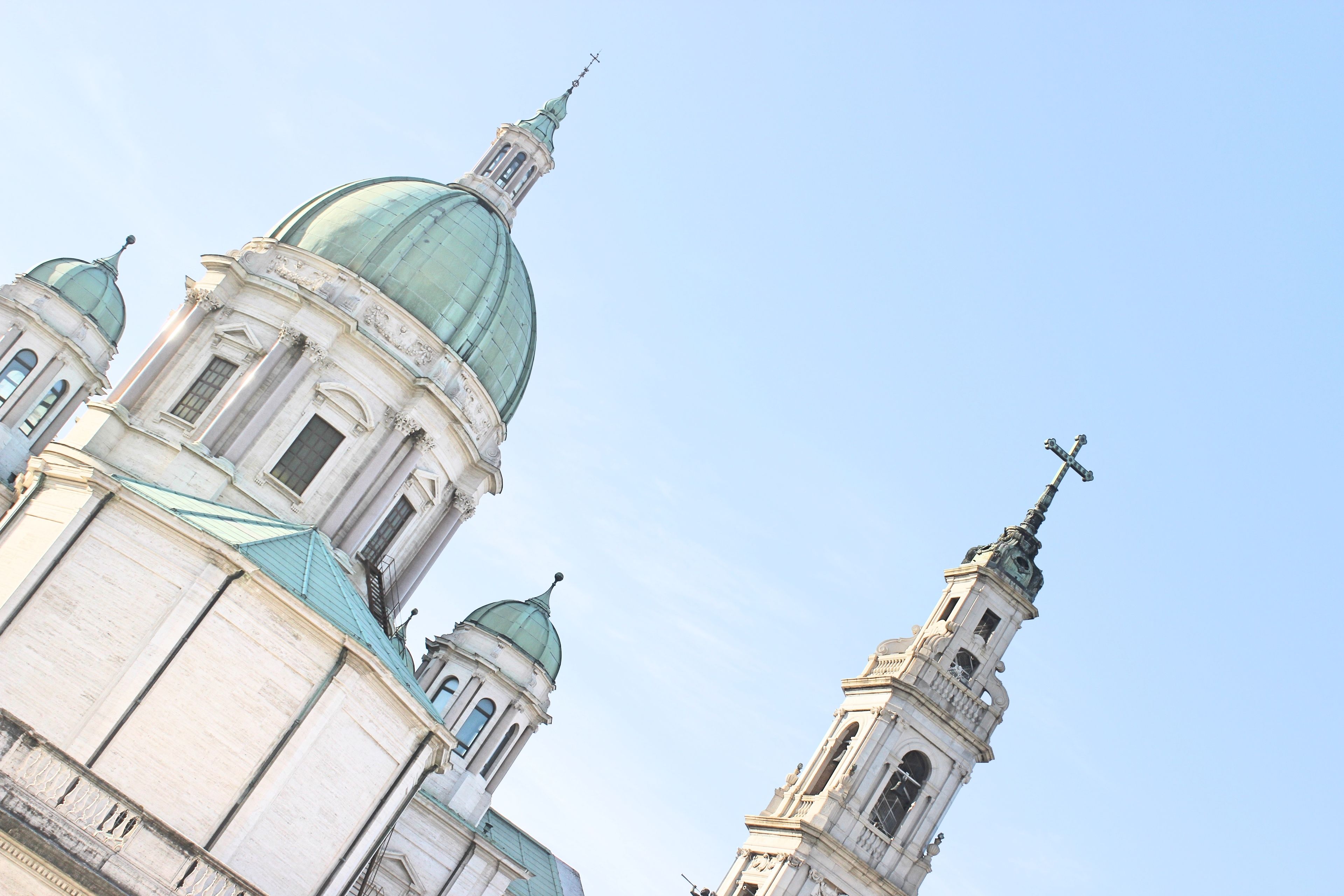 A church with multiple domes and a tall bell tower.