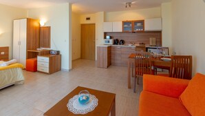A compact living space with a kitchenette, a dining area, and a bedroom. - Large Studio in Polo Resort (Sunny Beach)