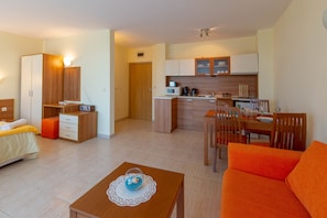 Family Studio, Balcony | Living area | TV