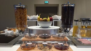 A breakfast buffet with various food items and beverages.