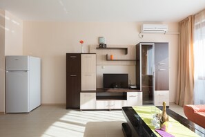Family Studio, Balcony | Living area | TV