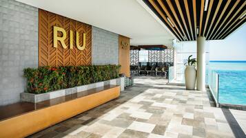 Welcome to Riju Palace Maldives, where a stylish lobby awaits with a seating area and beautiful views of the ocean.