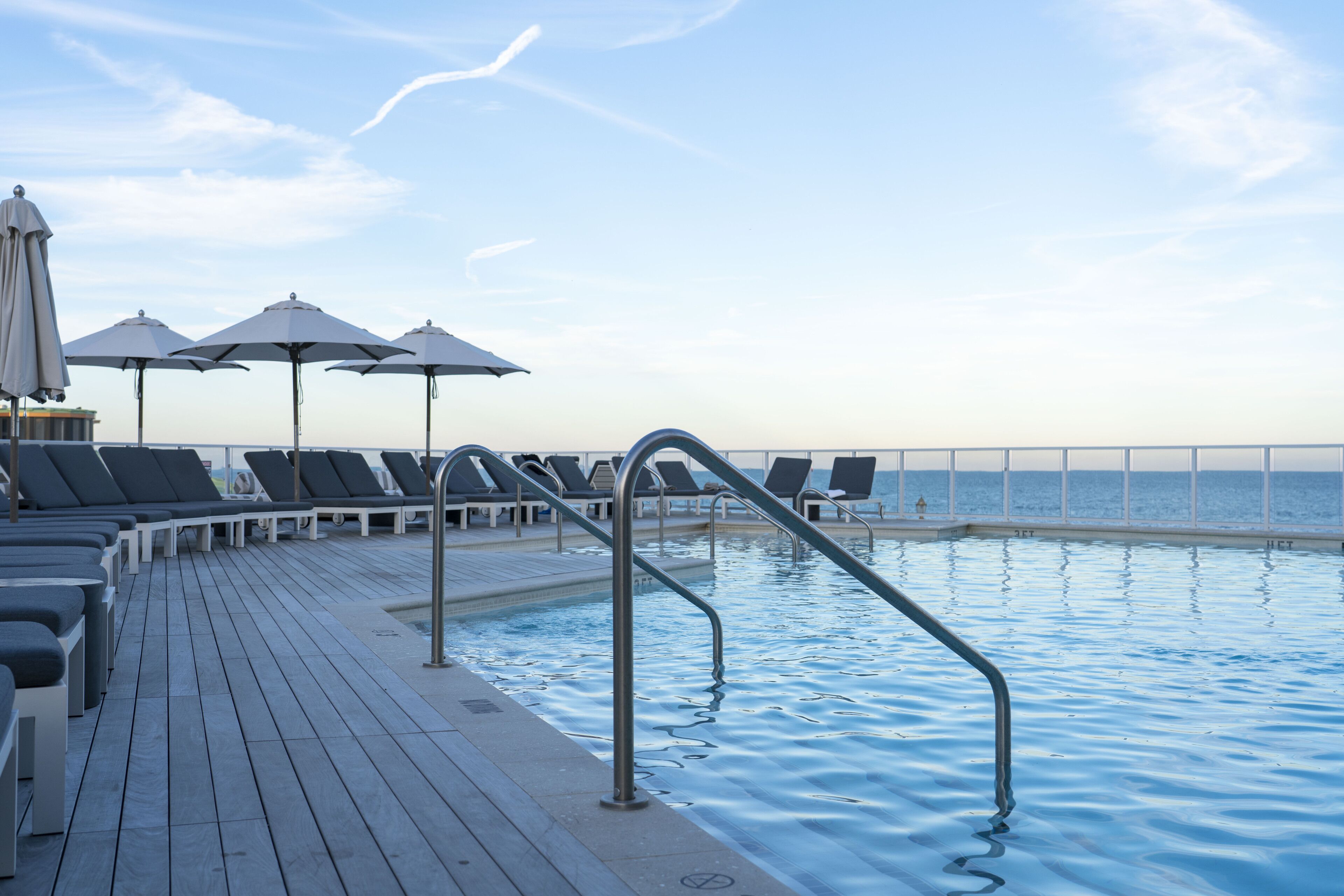 seasonal outdoor pool, open 8:00 am to 8:00 pm, pool umbrellas