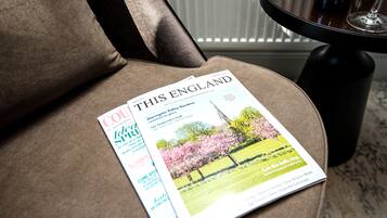 A magazine on a brown upholstered chair.