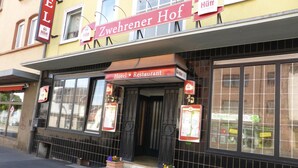 A hotel named "Zweihäuser Hof" with a sign indicating it's a hotel and restaurant. - Zwehrener Hof (Kassel)