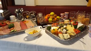 A buffet table with various food items including meats, cheeses, fruits, and vegetables. - Zwehrener Hof (Kassel)