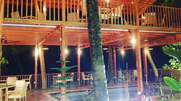A multi-level wooden structure with outdoor seating and a pool area. - Mariners Bay Resorts (Mandrem)