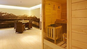A modern interior with a wooden sliding door leading to a sauna area, a seating area with a view of mountains, and a large window with a mountain view. - Hotel Greinwald (Marktoberdorf)