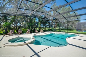A covered outdoor swimming pool with lounge chairs and a hot tub. - H6112 Beautiful 14 Bedroom 11 Bathroom Resoret (Davenport)