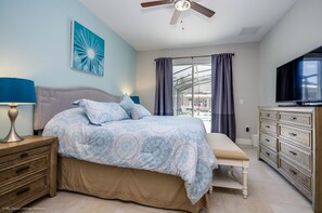 A bedroom with a bed, nightstand, dresser, and a ceiling fan. - H5294 Ultimate 6 Bedroom 5 Bathroom Home With Pool (Davenport)