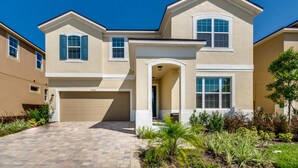 A two-story house with a garage, a covered entryway, and a landscaped front yard.