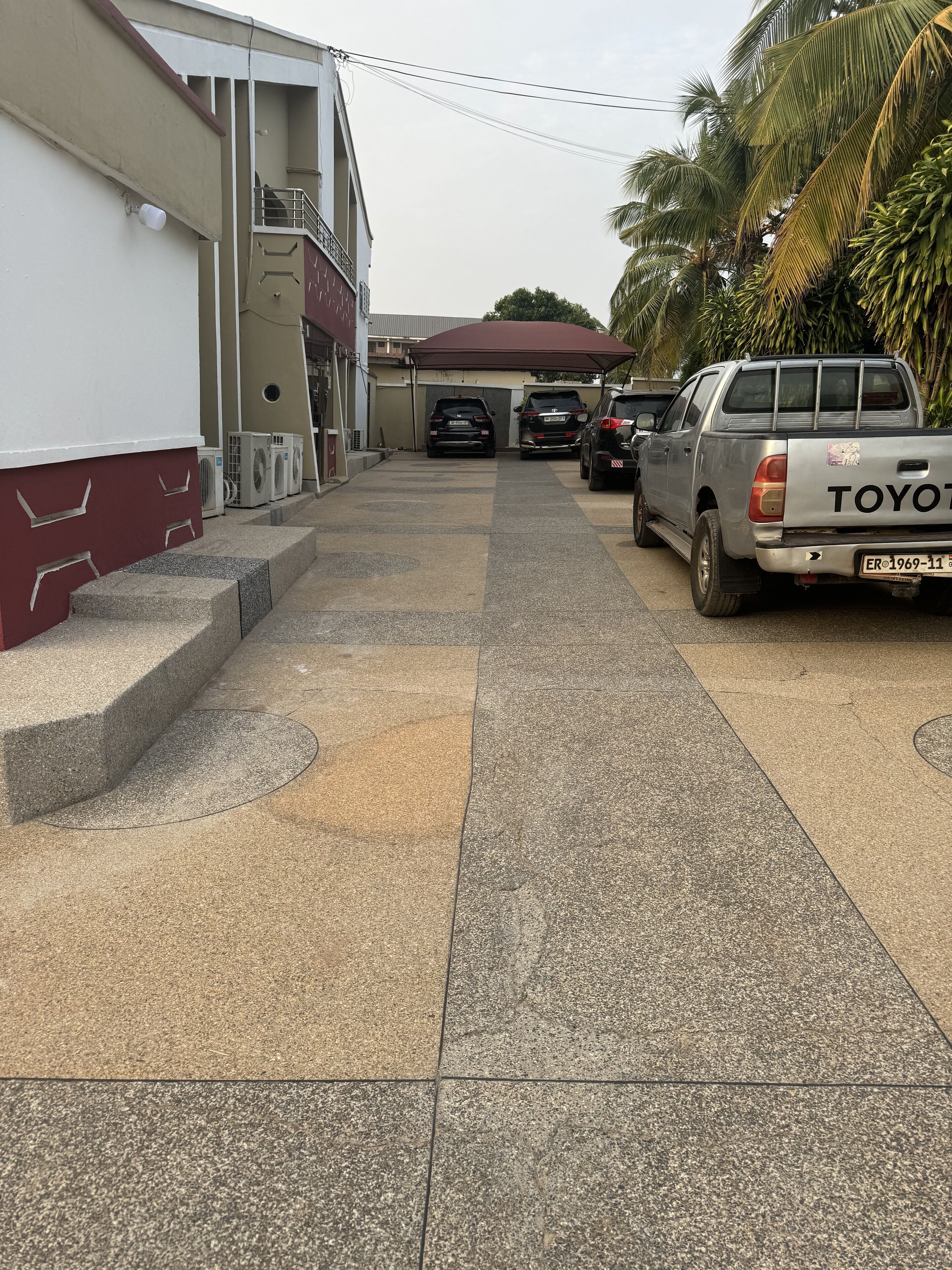 A driveway with a Toyota pickup truck parked on the right.