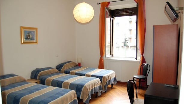 A room with four single beds, a desk, a chair, and a window with curtains. - B&B Citta Studi (Milan)