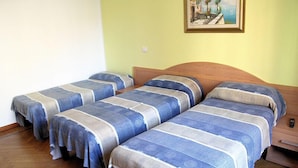 A room with three single beds, each with a blue and white striped bedspread. - B&B Citta Studi (Milan)