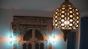 Une pièce dotée d’une porte décorative et d’un luminaire suspendu.
